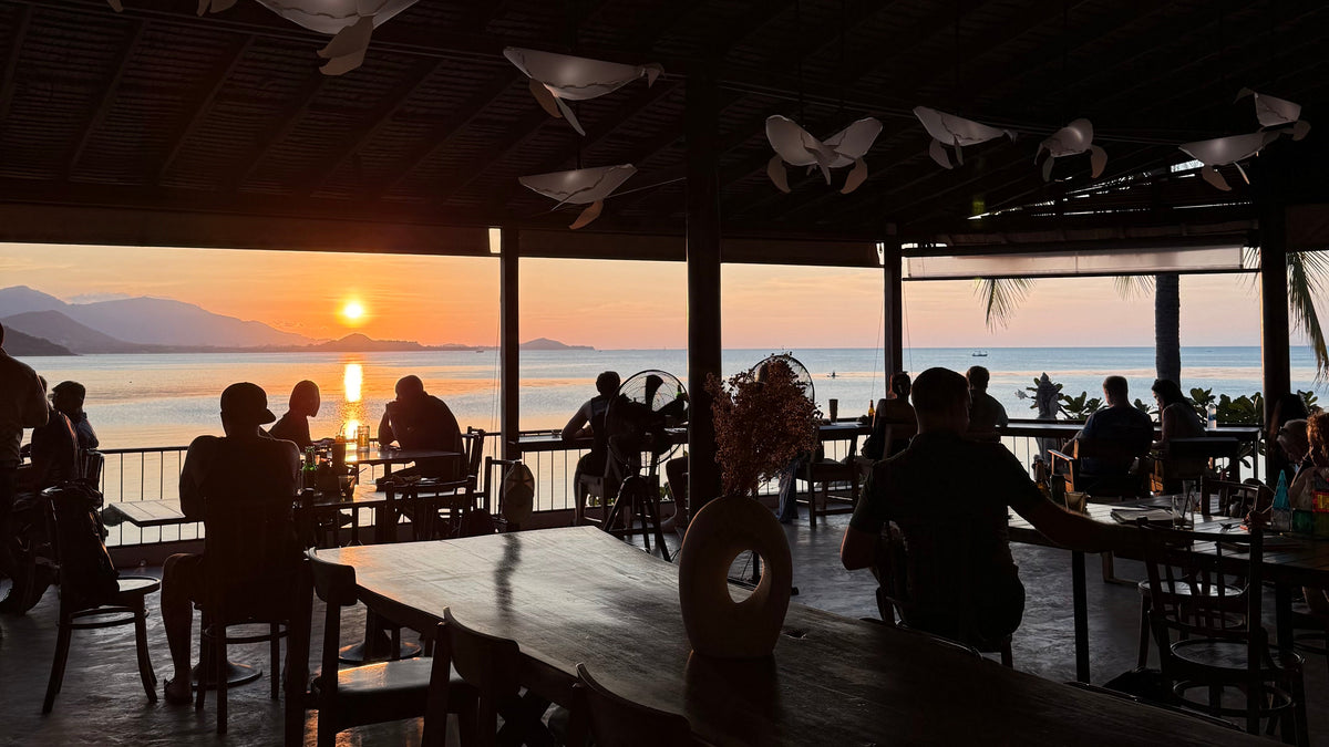 Sunset in Koh Samui, people eating at restaurant