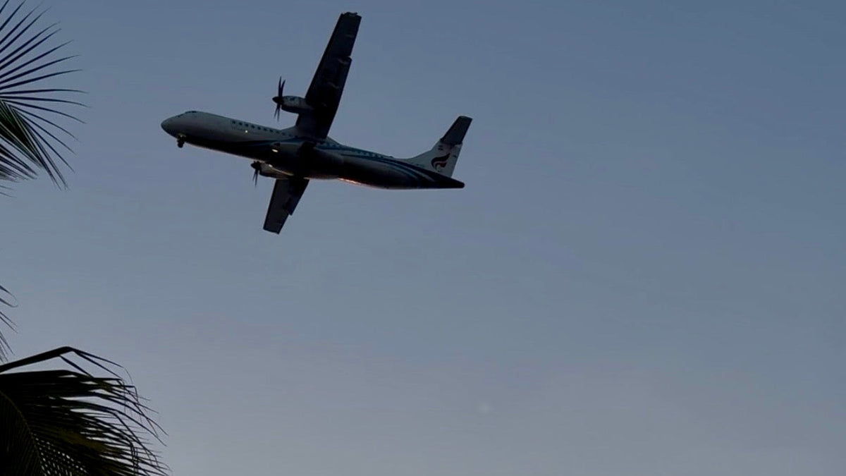 Plane arriving into Koh Samui at sunset