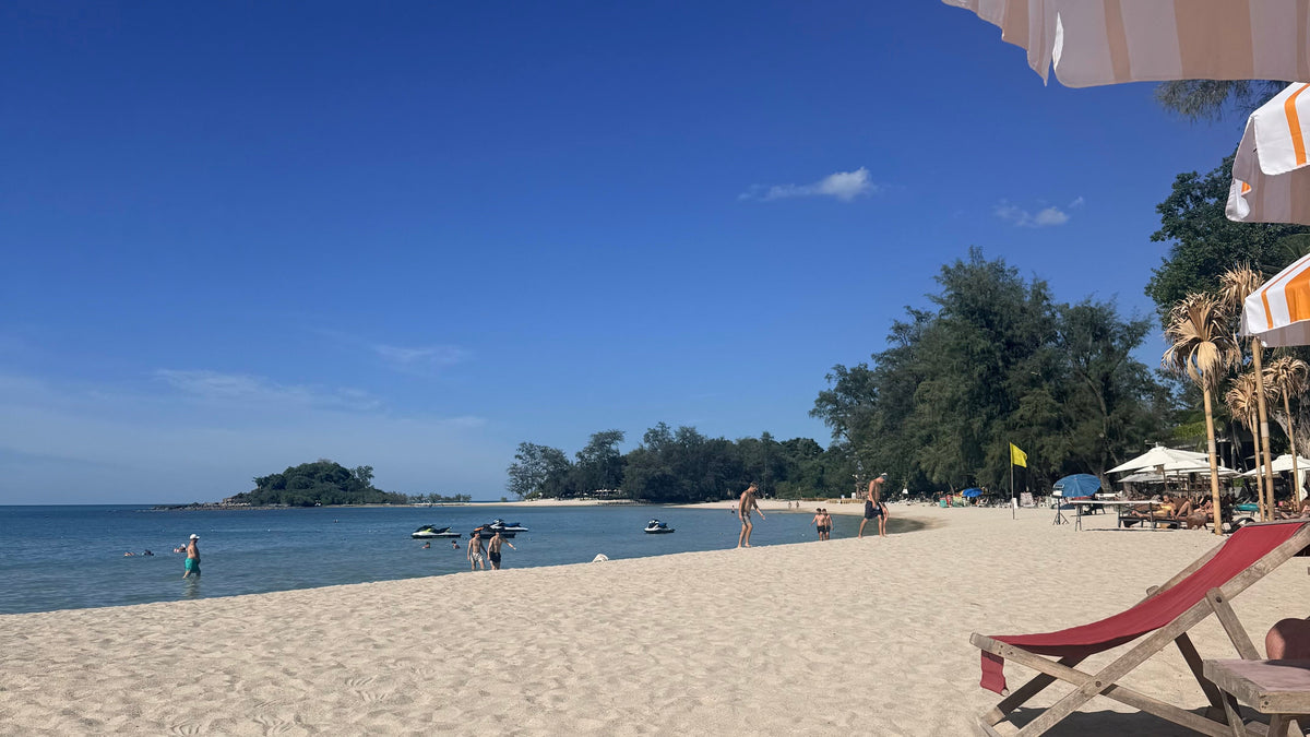 Choeng Mon Beach view from Carnival beach club, sun lounger and people walking on the beach
