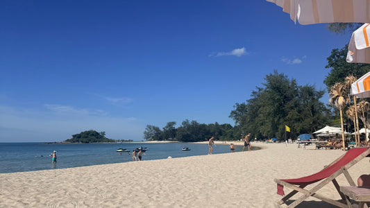 Choeng Mon Beach view from Carnival beach club, sun lounger and people walking on the beach