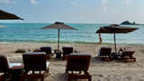 Parasols on Choeng Mon beach at Sala Choeng Mon hotel
